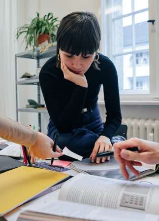 Woman designing secure software with two other people around a table