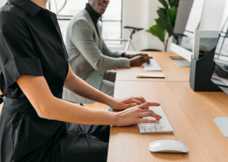 Software engineers sitting at their work stations typing on keyboards