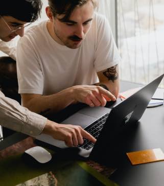 Two men inspecting code on an air-gapped laptop