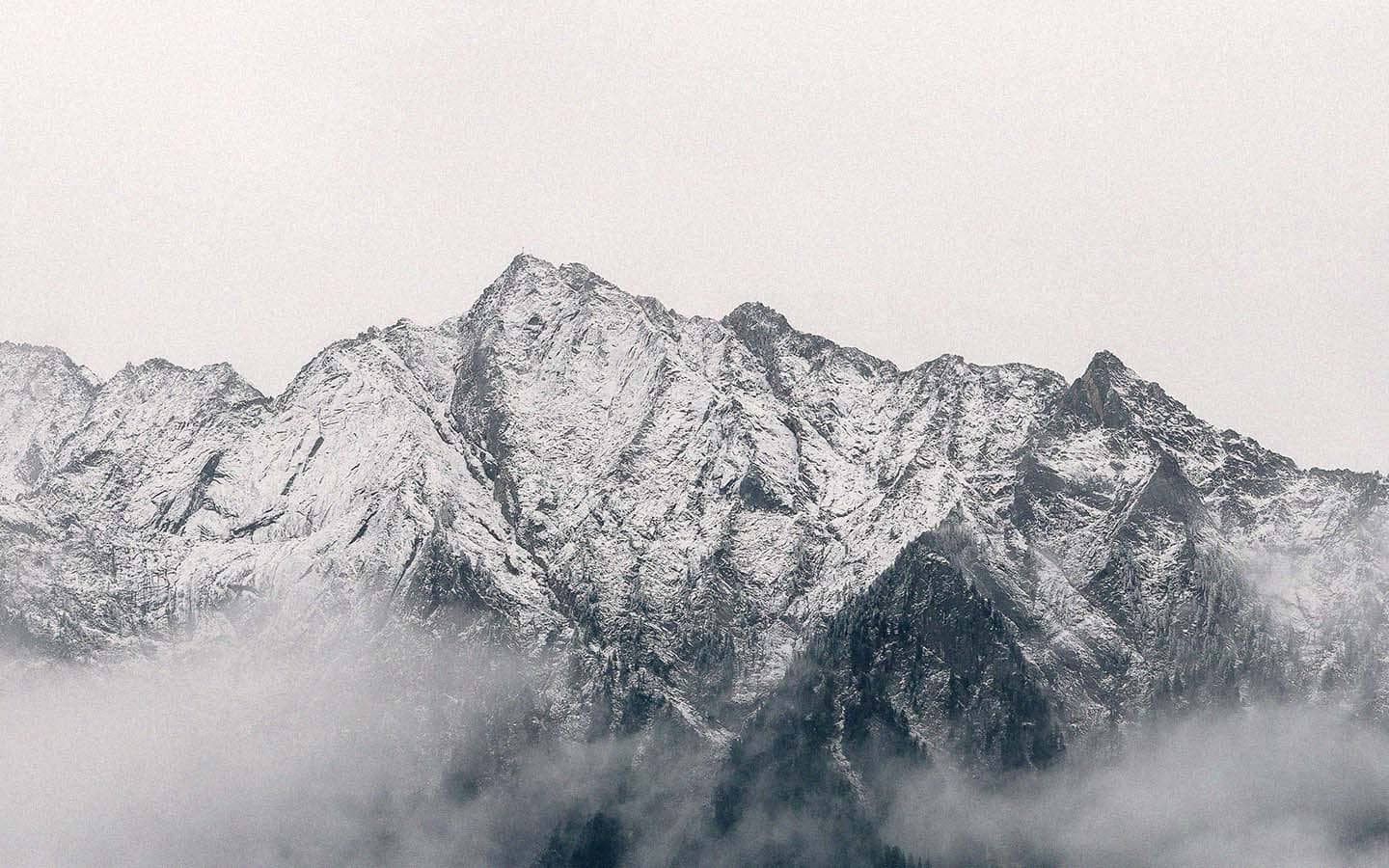 white sky behind mountains